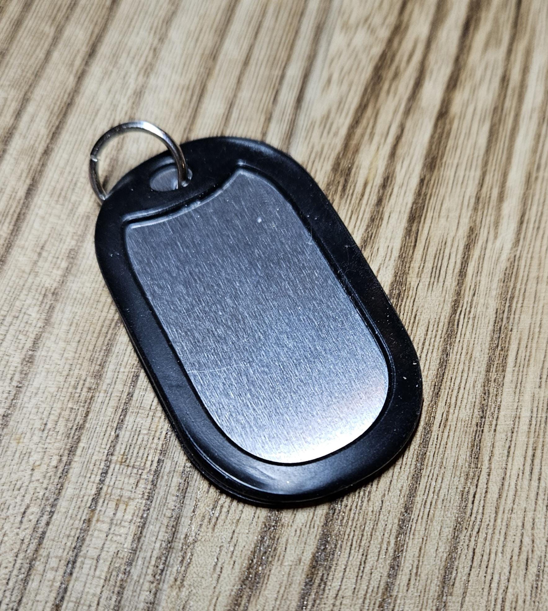 Black Dog Tag Rainbow RESIST each letter different color.