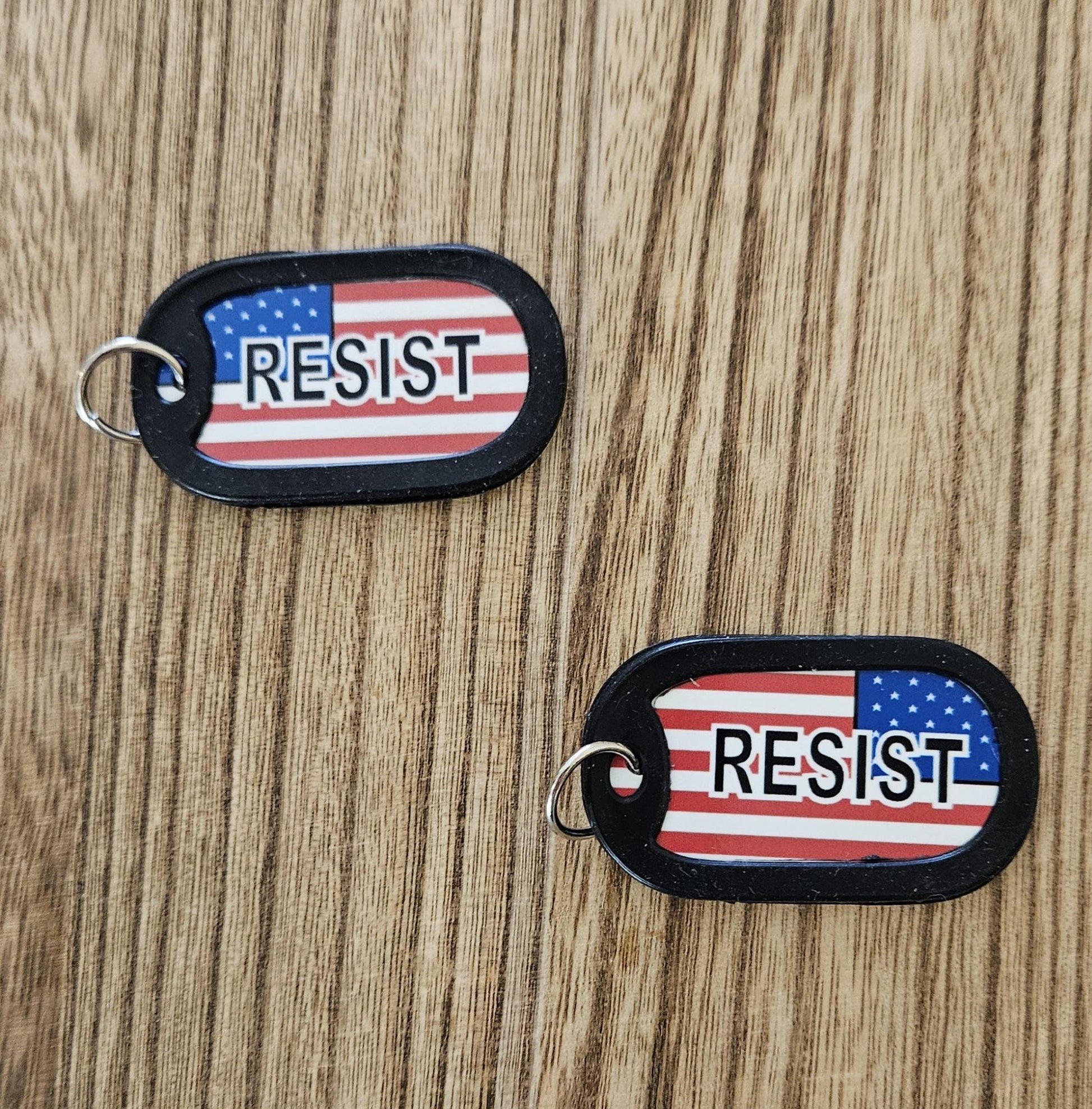 US Flag with RESIST (white outline black letters) avail in regular US Flag or in distress upside down flag